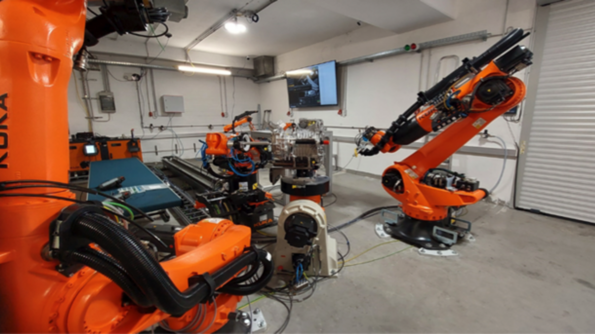 Das Bild zeigt verschiedene Roboterarme mit Werkzeugbahnhöfen und Positioniersystemen.