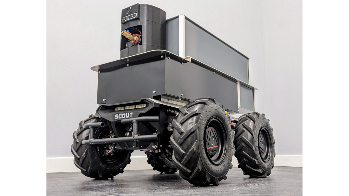 Das Bild zeigt ein autonomes Fahrzeug mit vier Rädern und kompaktem Aufbau mit Spritzdüse.